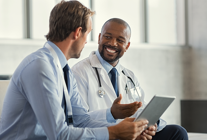 Doctor smiling while talking to a person